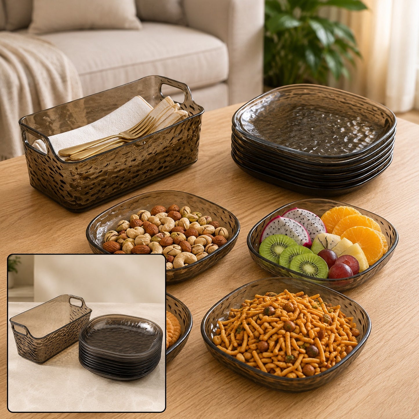 A set of dark gray textured plastic plates and a matching basket filled with snacks and fruit on a wooden table.