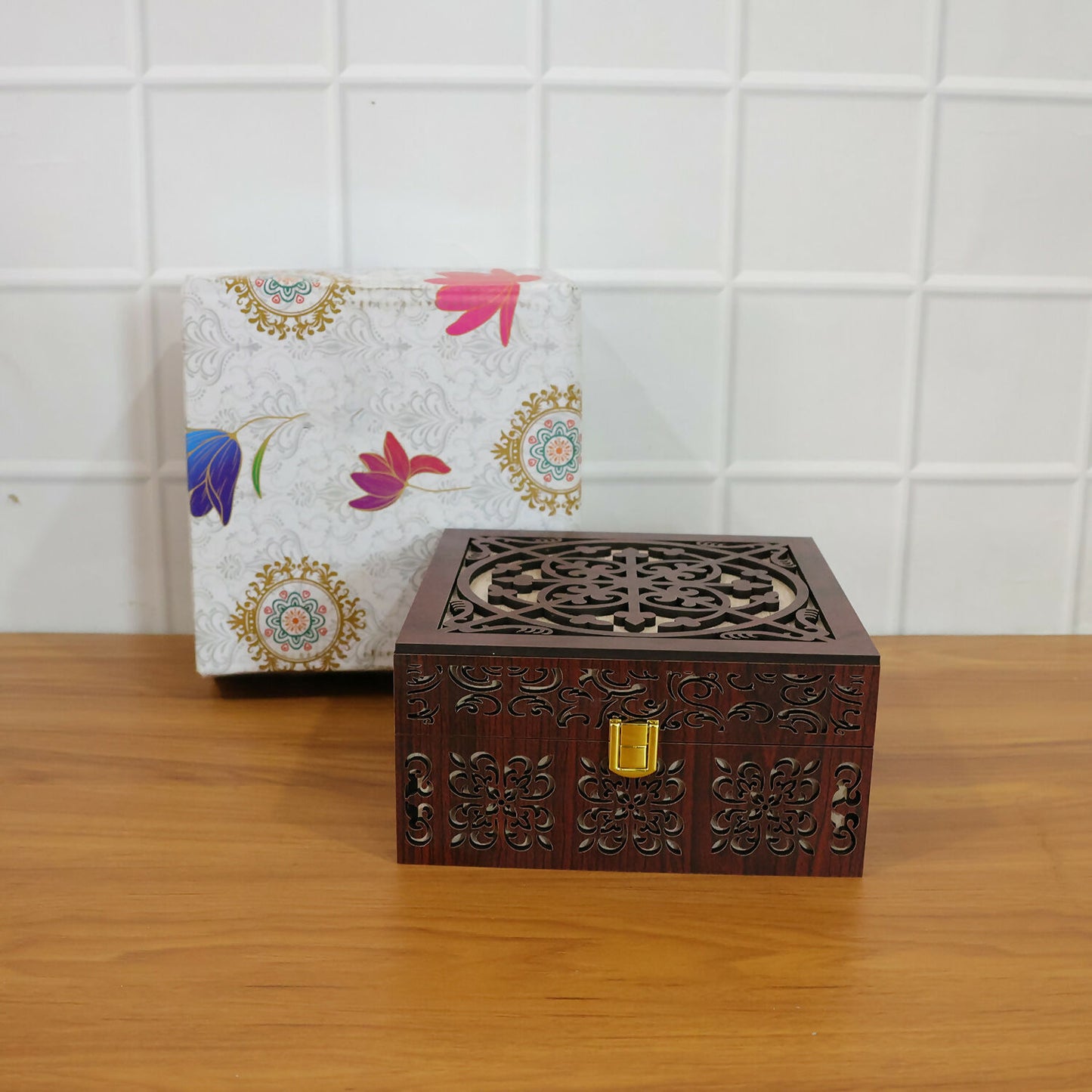 Detailed shot of hand-carved wooden patterns and polished gold-tone metal clasp of wooden storage box
