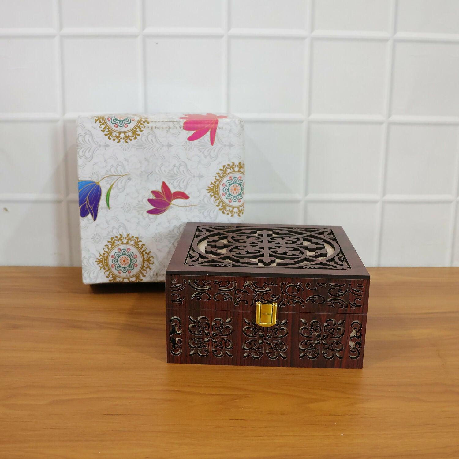 Detailed shot of hand-carved wooden patterns and polished gold-tone metal clasp of wooden storage box