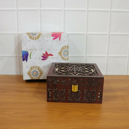 Detailed shot of hand-carved wooden patterns and polished gold-tone metal clasp of wooden storage box