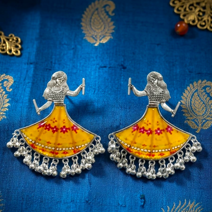 Two identical silver-toned earrings with yellow and red floral skirts, each adorned with tiny dangling ghungroos.