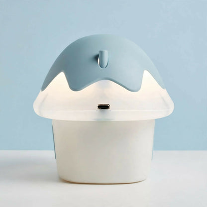 The back of a light blue and white mushroom house night light, showing a USB-C charging port on the cap.