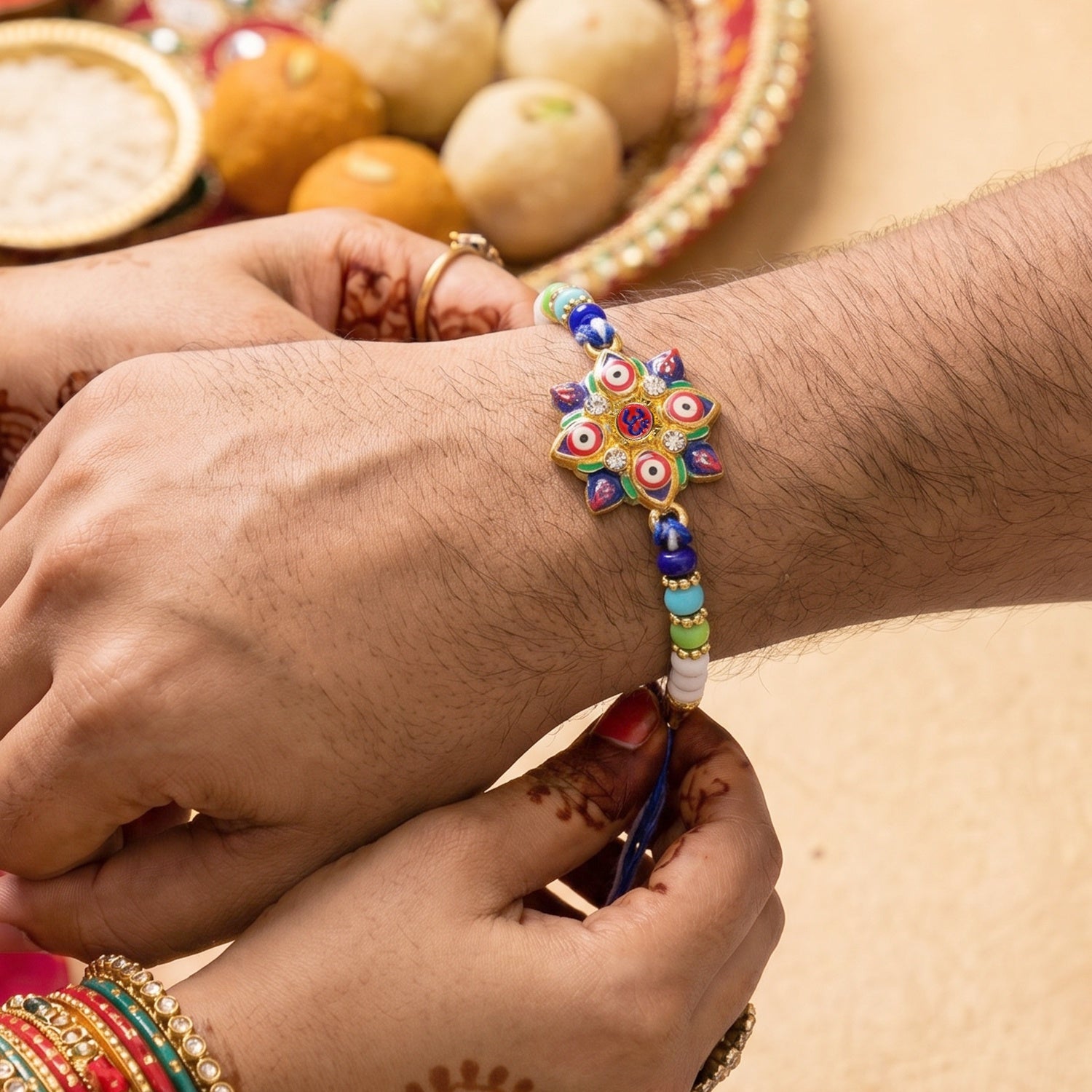 Close-up of Multi Evil Eye OM Star Designer Rakhi centerpiece