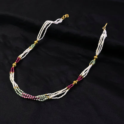 Close-up of pearl beads with dual-tone pink and mint accents on mala necklace