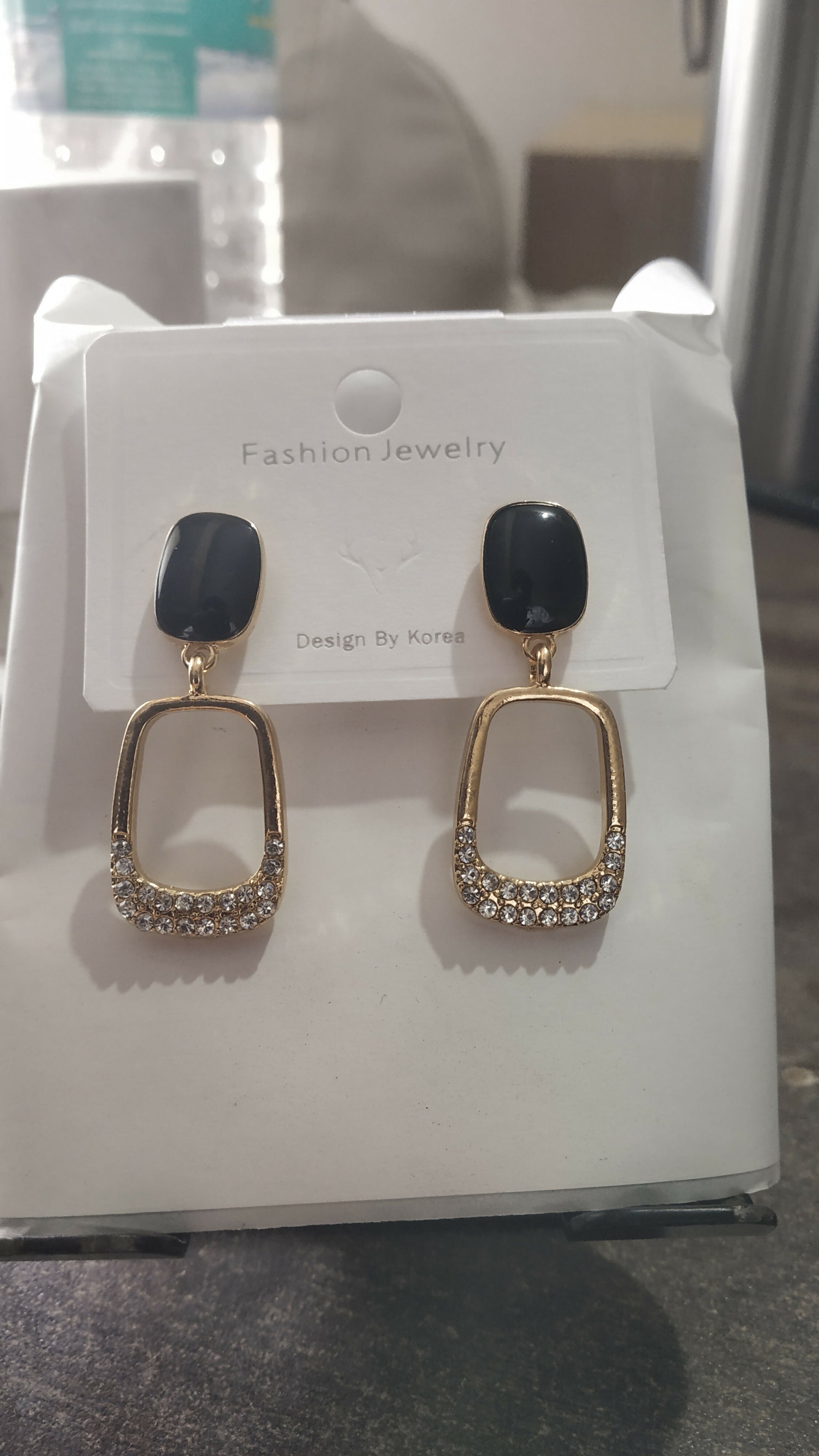 Black stone geometric drop earrings worn by model