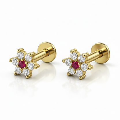 Close-up of ruby center and diamond accents on gold plated flower stud earring