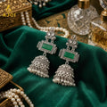 Oxidized Silver Jhumka Earrings – Deep Green Stone & Pearl Drops