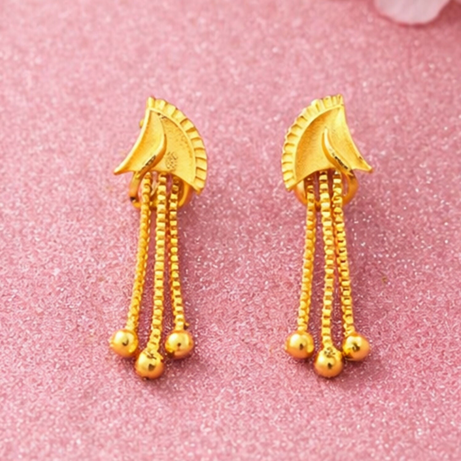 Side angle showing stylish golden drop earrings for party wear