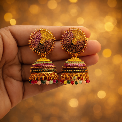 Traditional jhumka earrings with pink, green, and gold beadwork on round stud