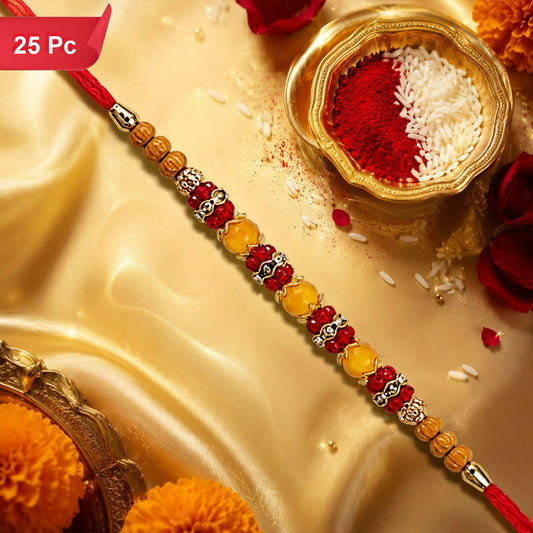 A red thread bracelet with yellow and red beads, gold accents, and a small bowl of red powder and rice on a golden fabric