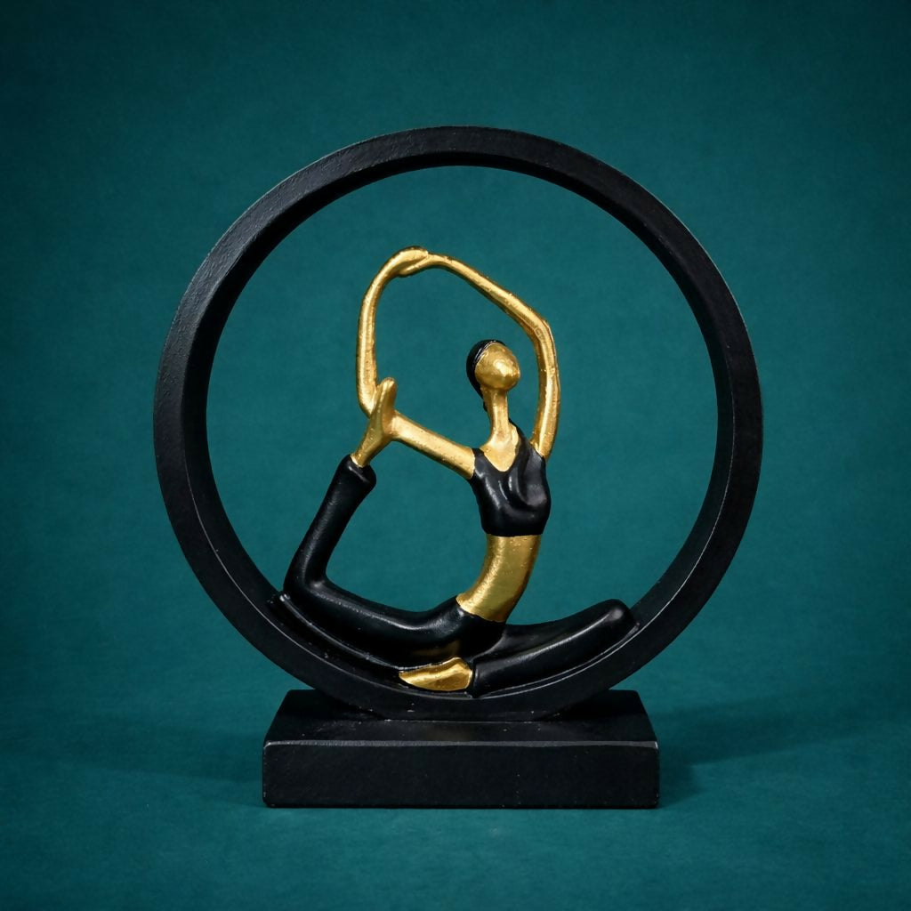 Side view of black gold yoga meditation figurine showpiece on table