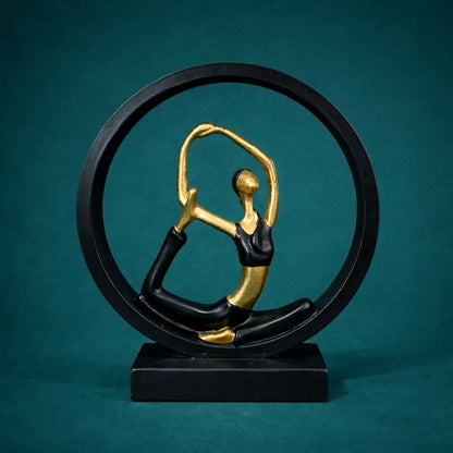 Side view of black gold yoga meditation figurine showpiece on table