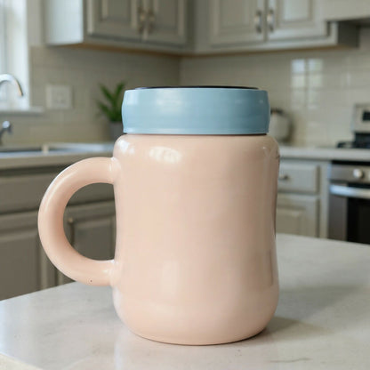 Close up of cartoon design on ceramic mug with lid