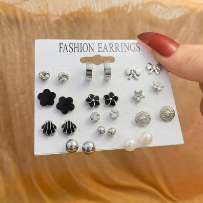Close-up view of silver and black minimal stud earrings in the set