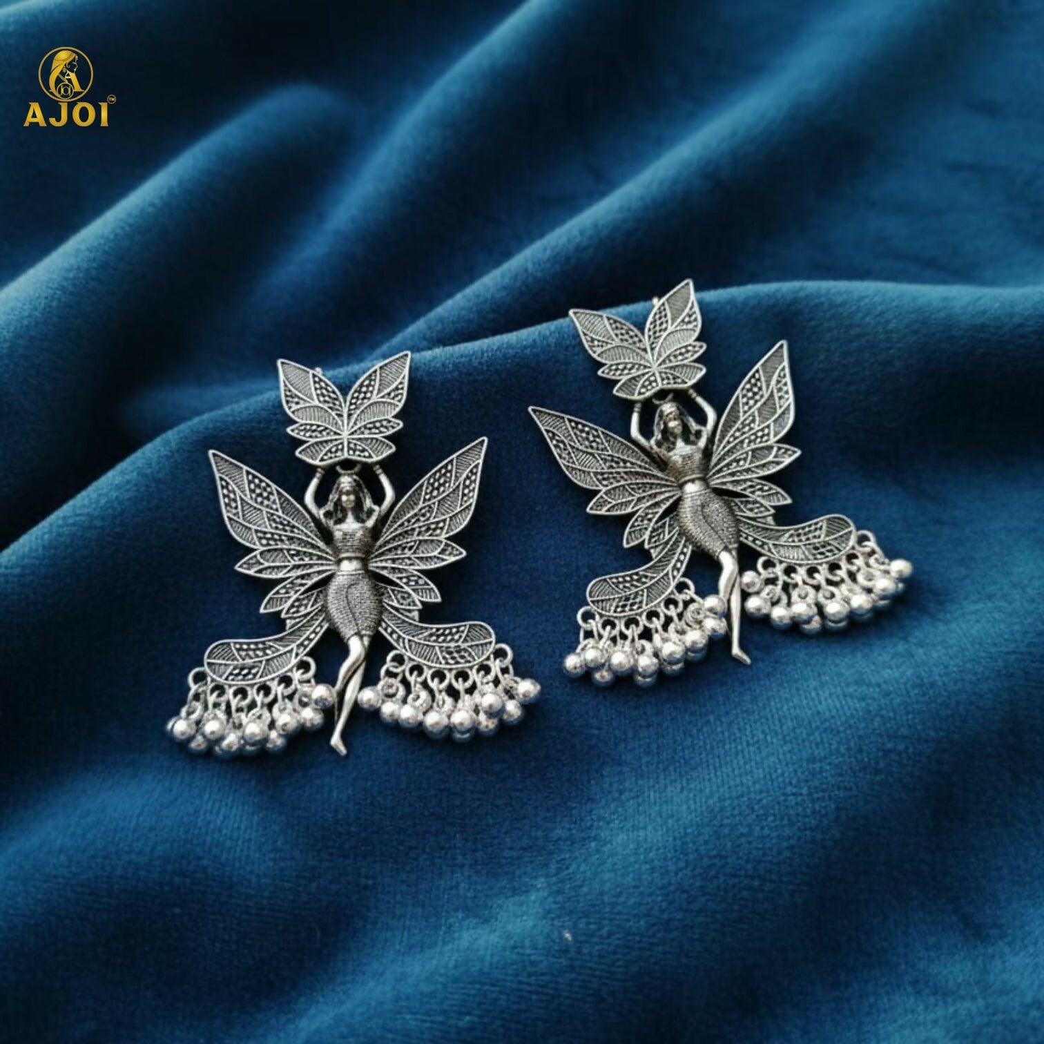 Oxidized silver earrings with dangling beads on display