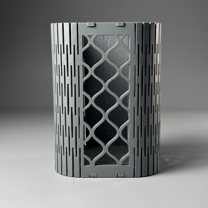 Elegant geometric mesh pen holder on a wooden desk with other office essentials.