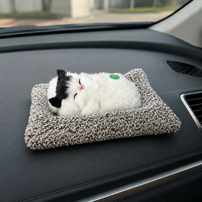 Sleeping cat plush toy on fluffy cushion base for car or home décor