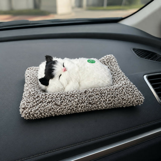 Sleeping cat plush toy on fluffy cushion base for car or home décor
