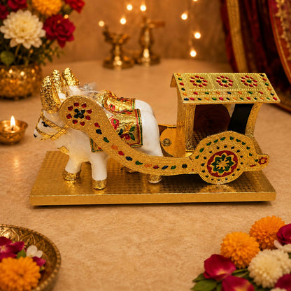 Intricate golden carving on bullock cart showpiece