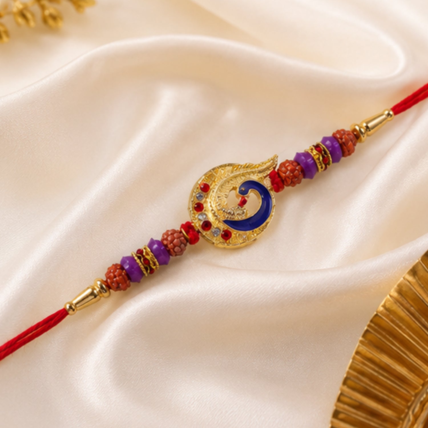 Blue Peacock Rakhi with Purple Beads and Crescent Gold Frame