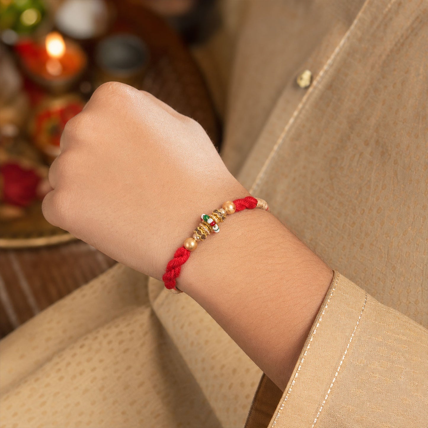 Red Twisted Cord Rakhi with a Colourful Enamel Bead and Gold Accents