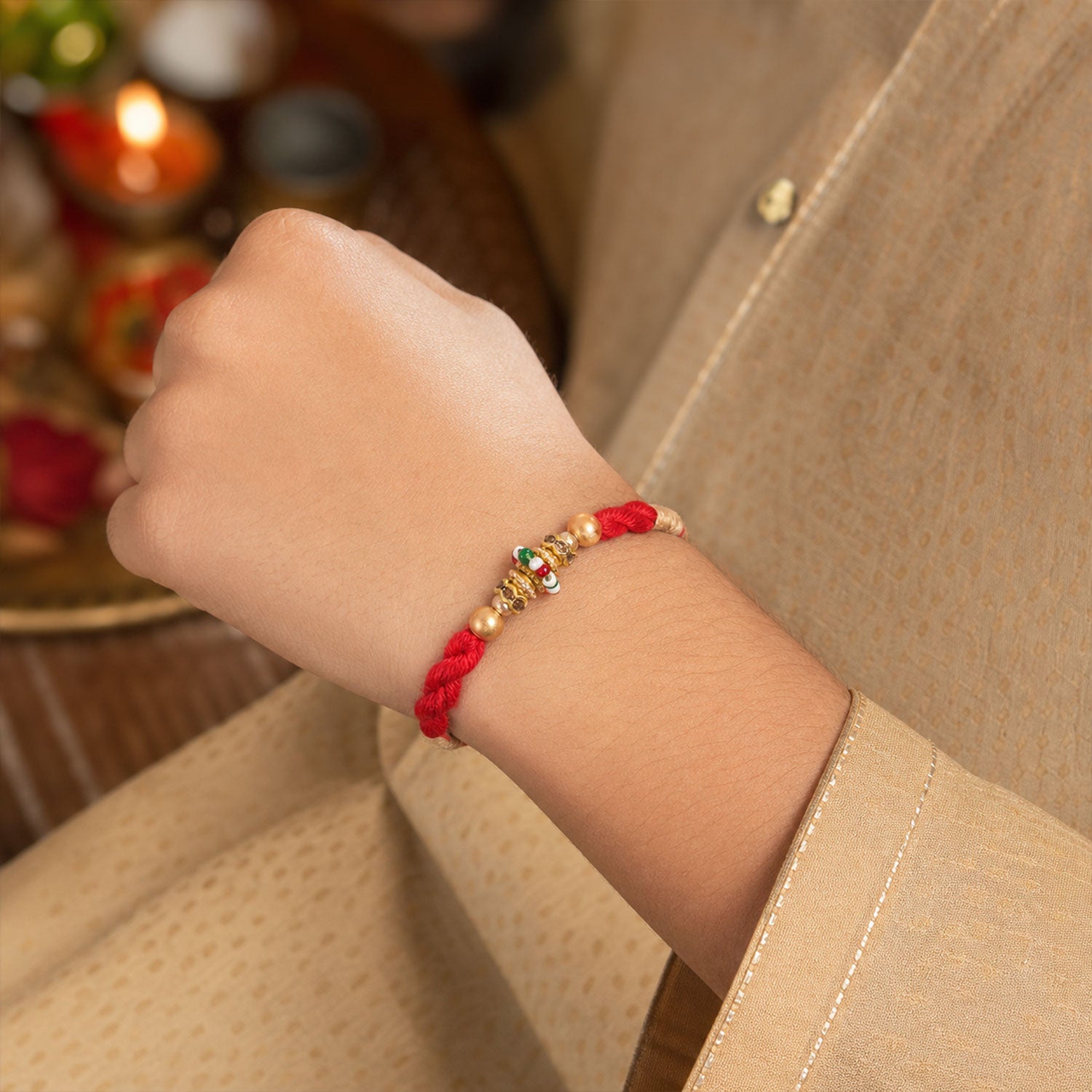 Red Twisted Cord Rakhi with a Colourful Enamel Bead and Gold Accents