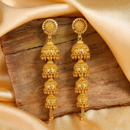 Gold tone jhumka earrings with intricate design