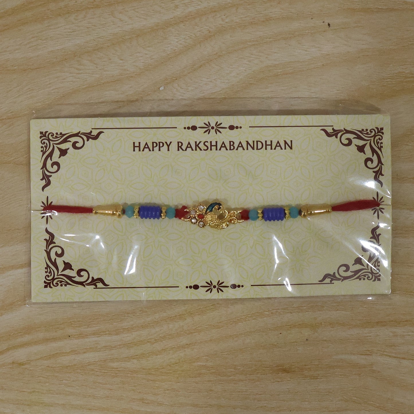 Antique Mini Peacock Designer Rakhi with ethnic wear background