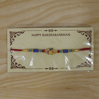 Antique Mini Peacock Designer Rakhi with ethnic wear background