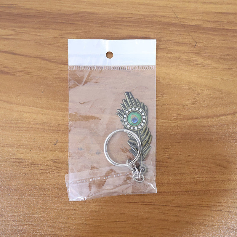 Krishna Mor Pankh Metal Keychain – Peacock Feather with Stone Work