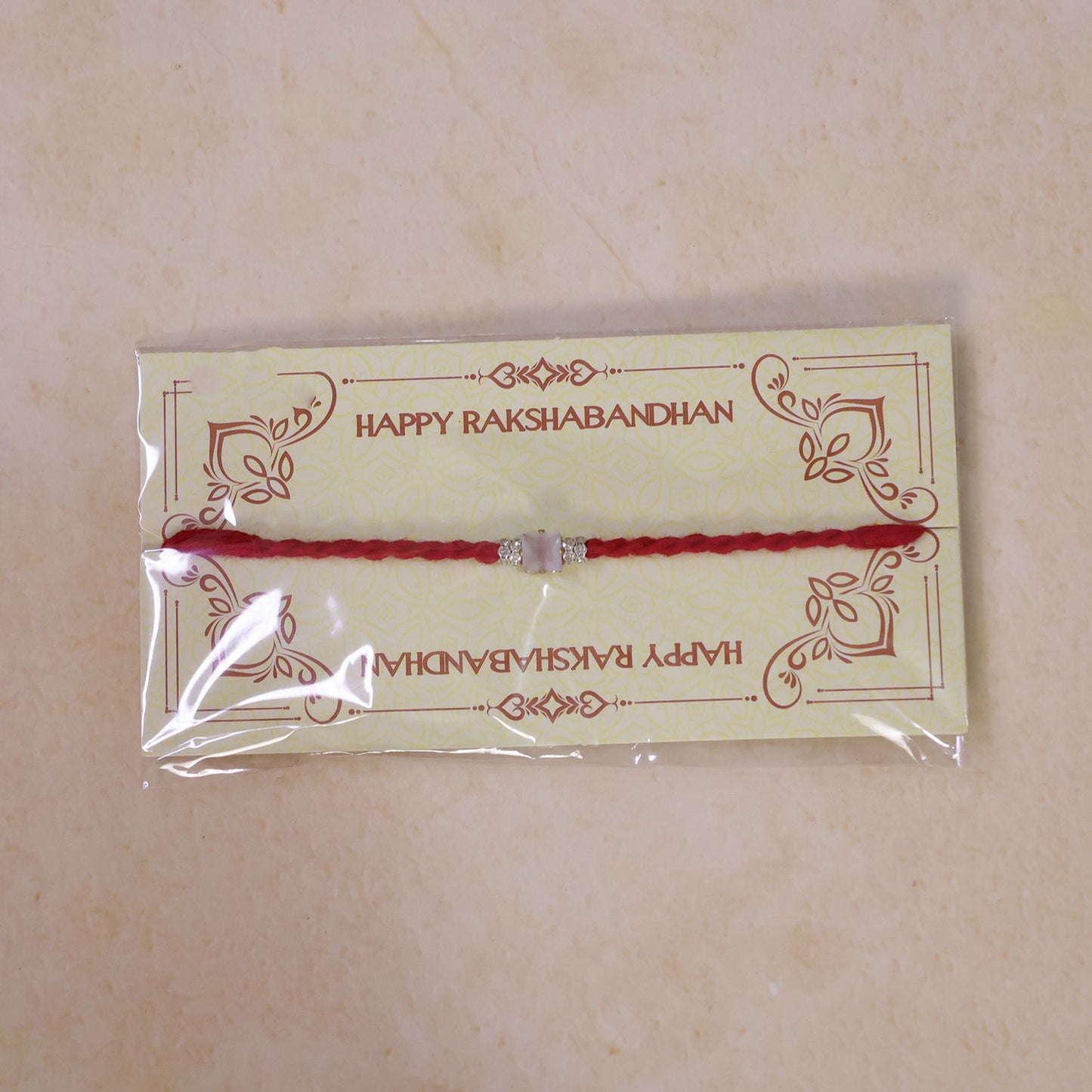 Red Twisted Cord Rakhi with a Bold Square Crystal Stone Pendant