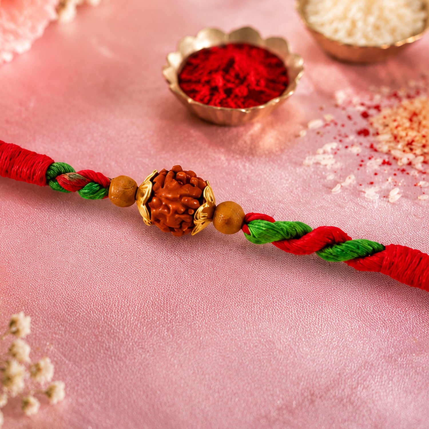 Green Red Designer Rakhi with Golden Bead Accents and Traditional Festive Beauty