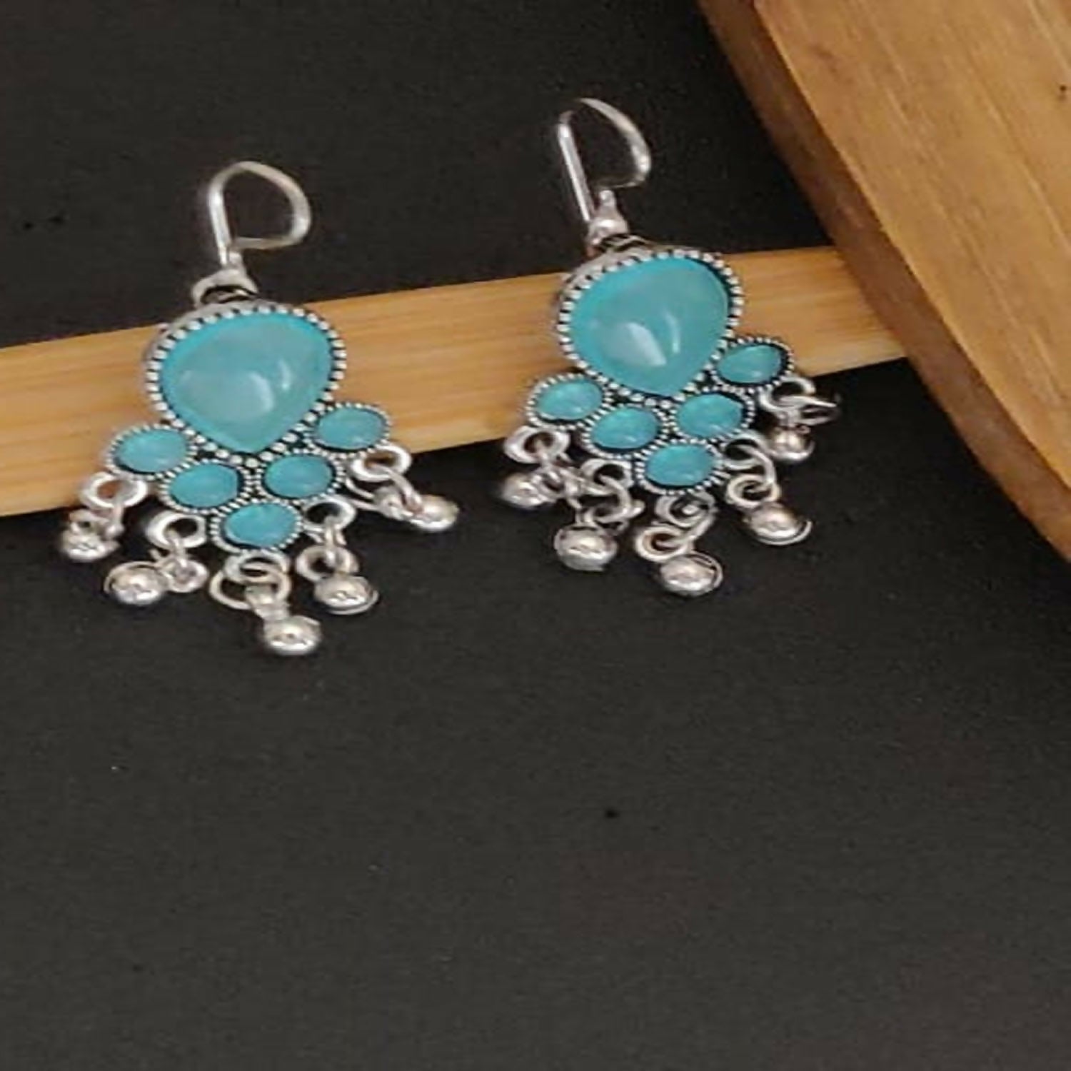 Elegant pearl jhumka earrings with intricate oxidised patterns on display