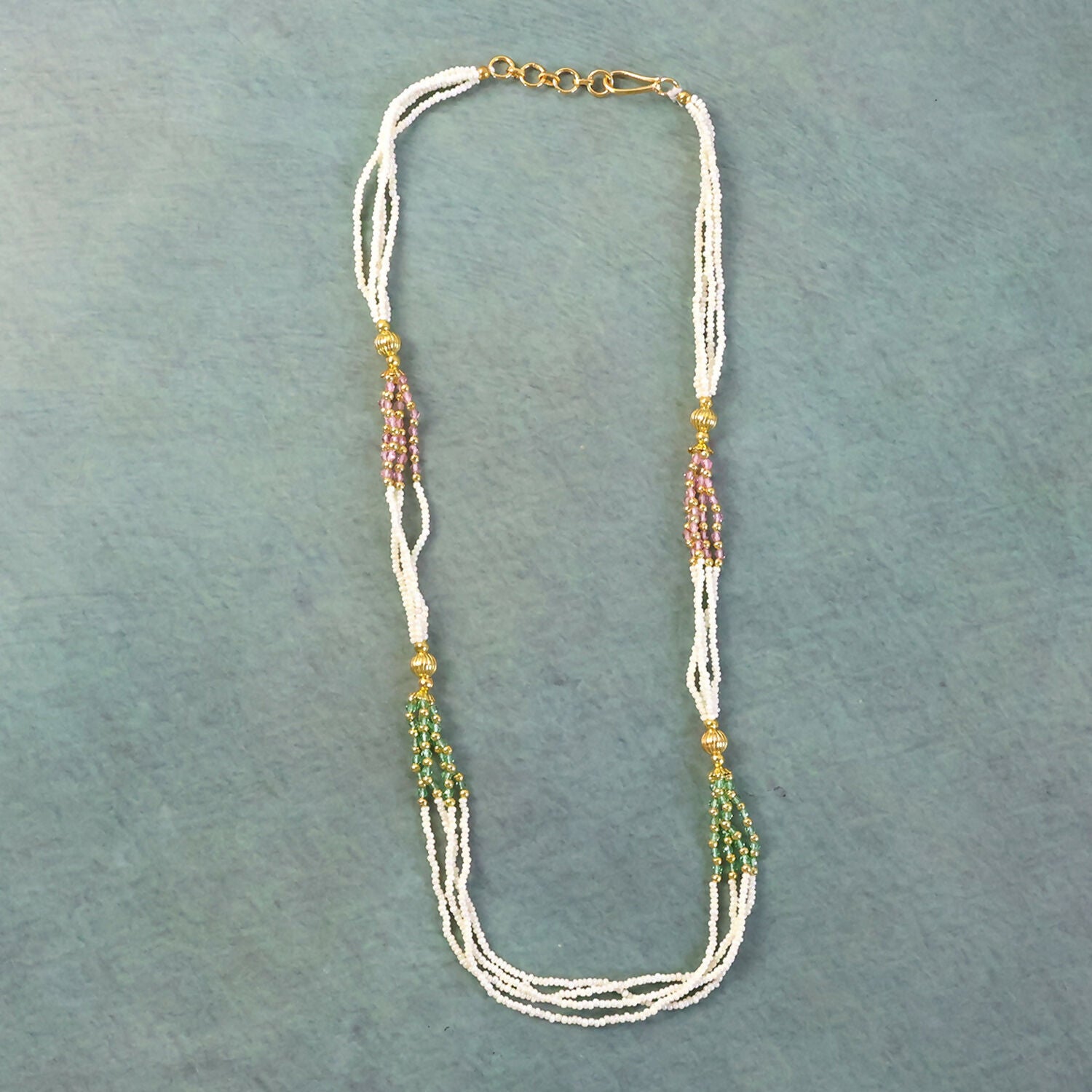 Close-up of traditional mala necklace beadwork with gold-toned details