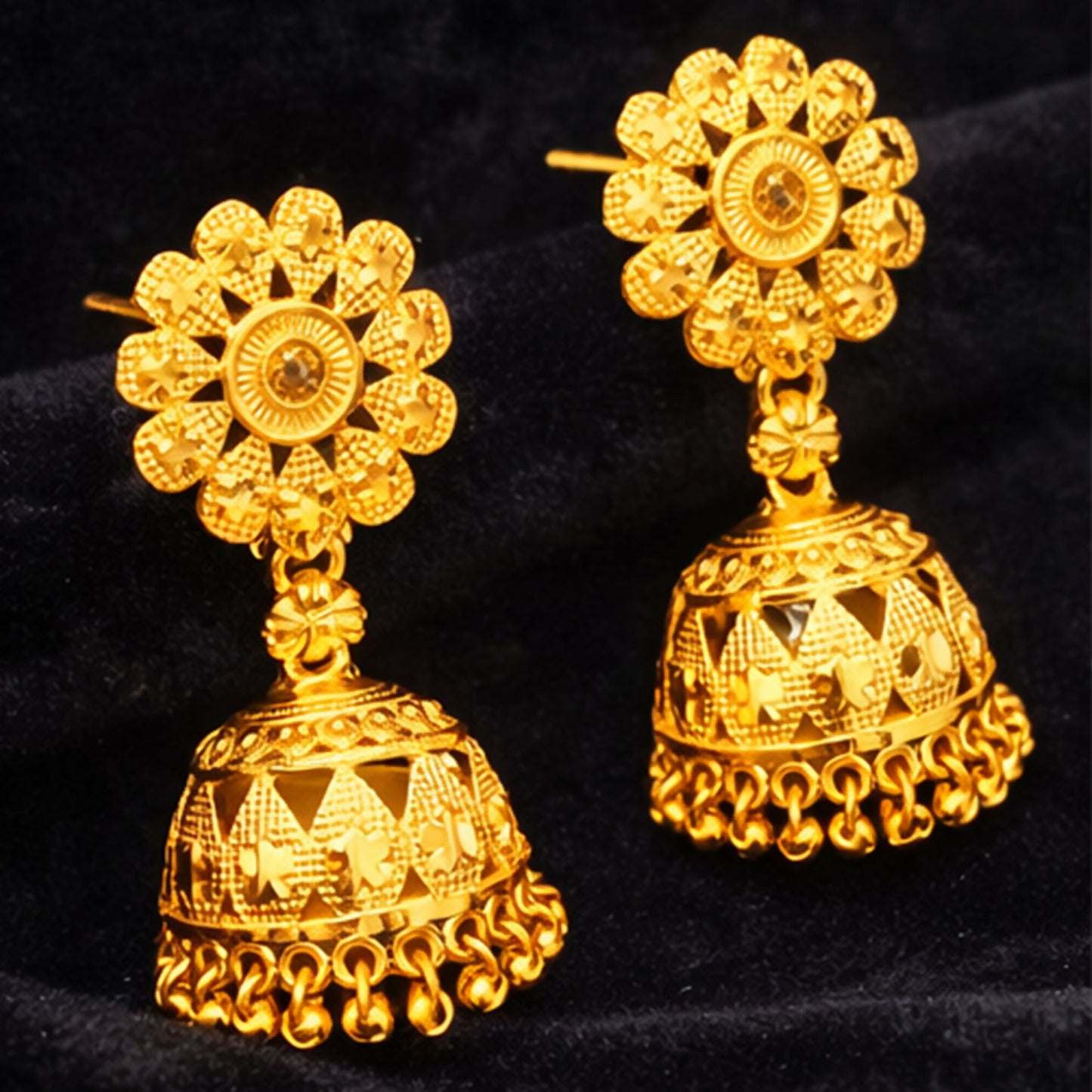 Side view of gold plated ethnic jhumka earrings showing detailed carving and rich finish