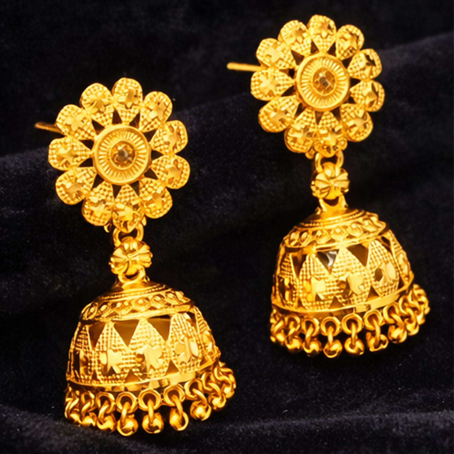 Side view of gold plated ethnic jhumka earrings showing detailed carving and rich finish