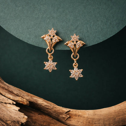 Rose gold star drop earrings featuring dainty floral charms with cubic zirconia stones
