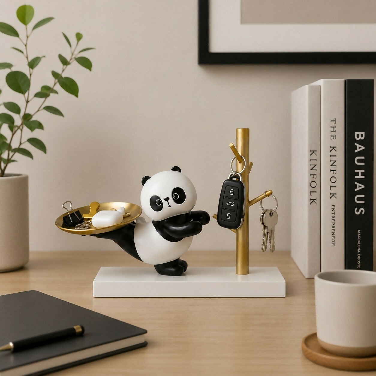 Cute panda resin organizer stand with a golden tray for keys and accessories.