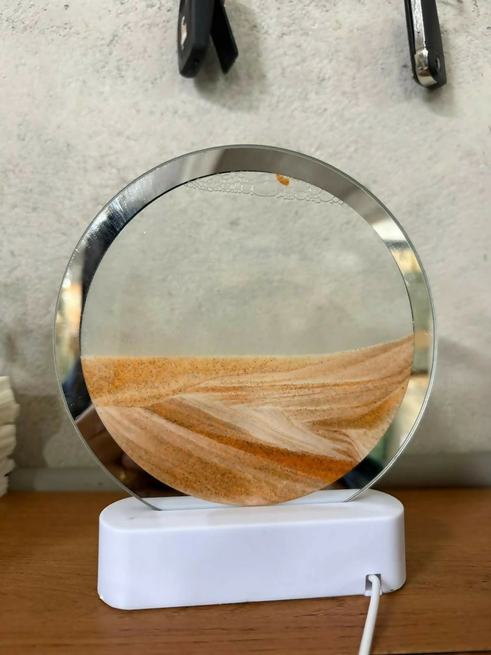 Moving sand art lamp on bedside table with LED light