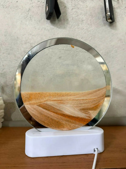 Moving sand art lamp on bedside table with LED light
