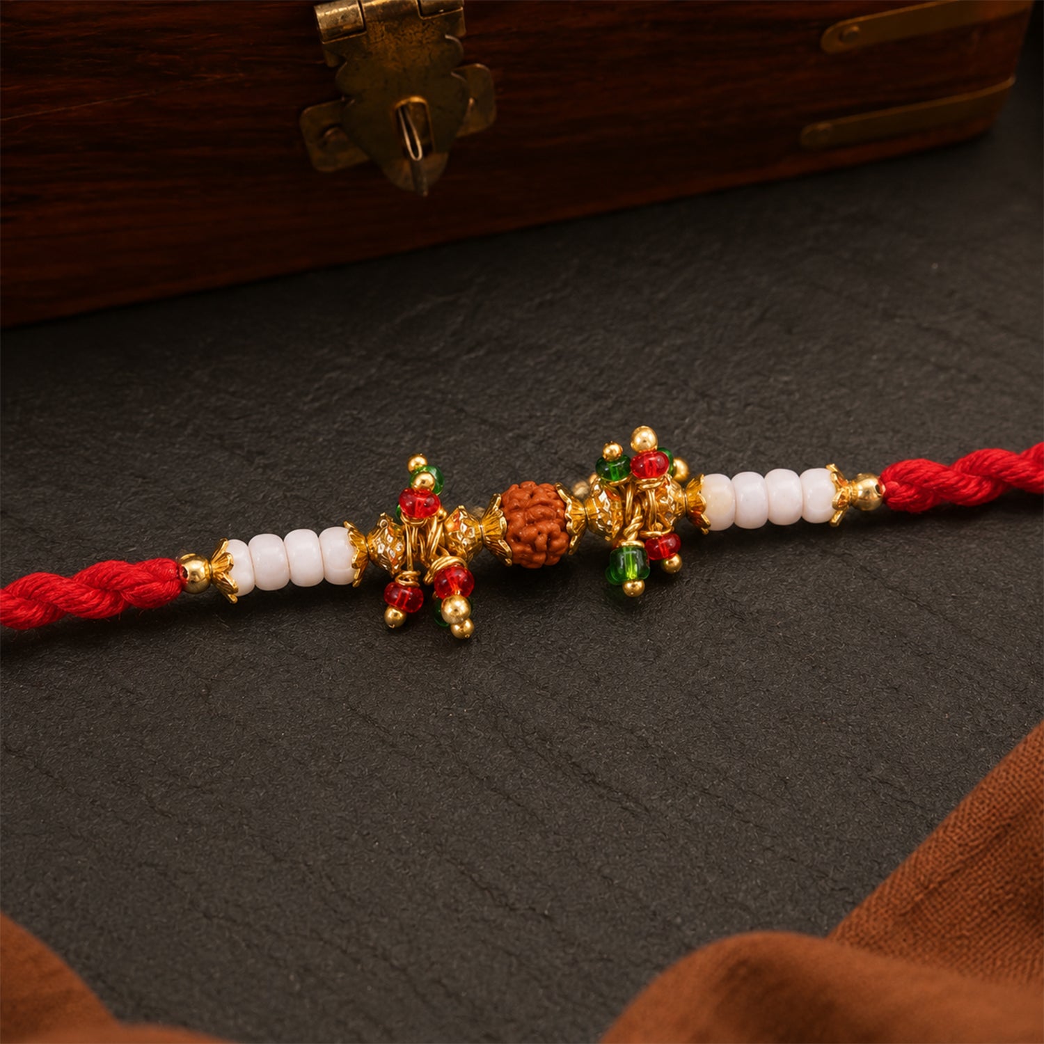Red Pearl Designer Rakhi with Golden Accents and Compact Festive Beauty