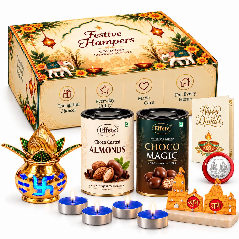A festive hamper box with two chocolate tins, a golden kalash, four blue tealights, and Shubh-Labh decor.