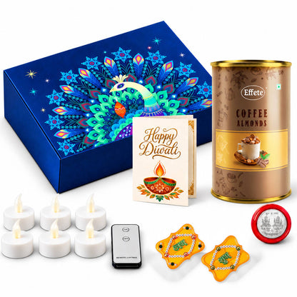 A blue box with a peacock design, a tin of coffee almonds, a Diwali card, six LED tealights, a remote, two Shubh Labh