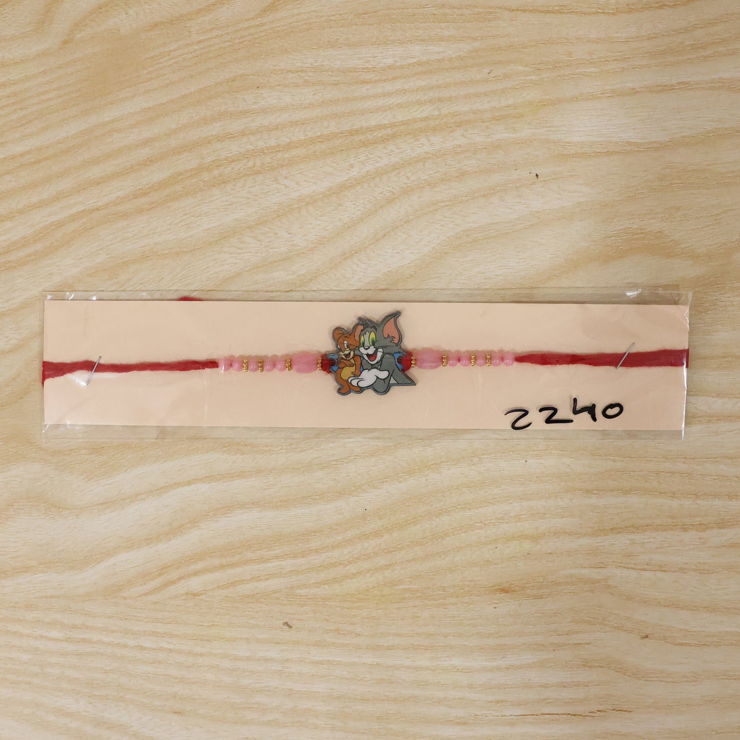 Cartoon Kids Rakhi with Pink Beads and Gold Accents