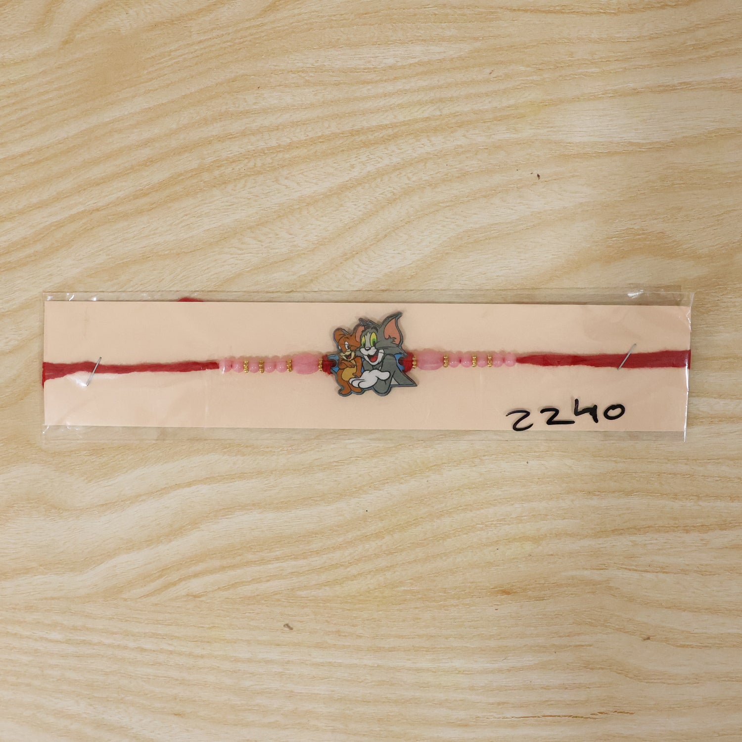 Cartoon Kids Rakhi with Pink Beads and Gold Accents