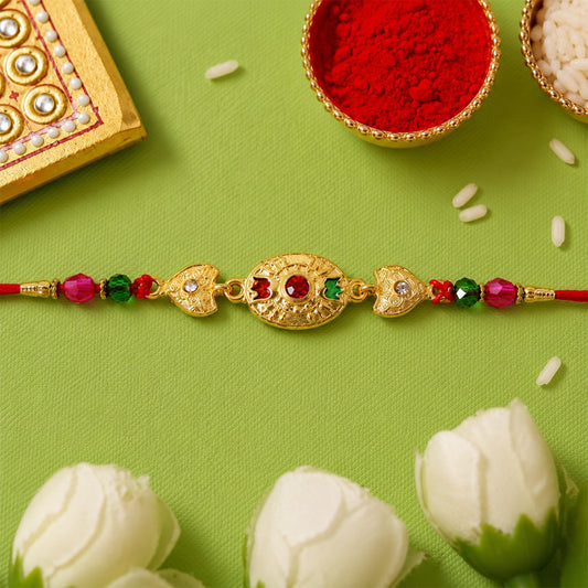 Gold stone rakhi with vibrant colourful beads, a traditional Raksha Bandhan thread.