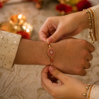 Round Red Chakra Rakhi with Golden Beads and Pearl Side Work