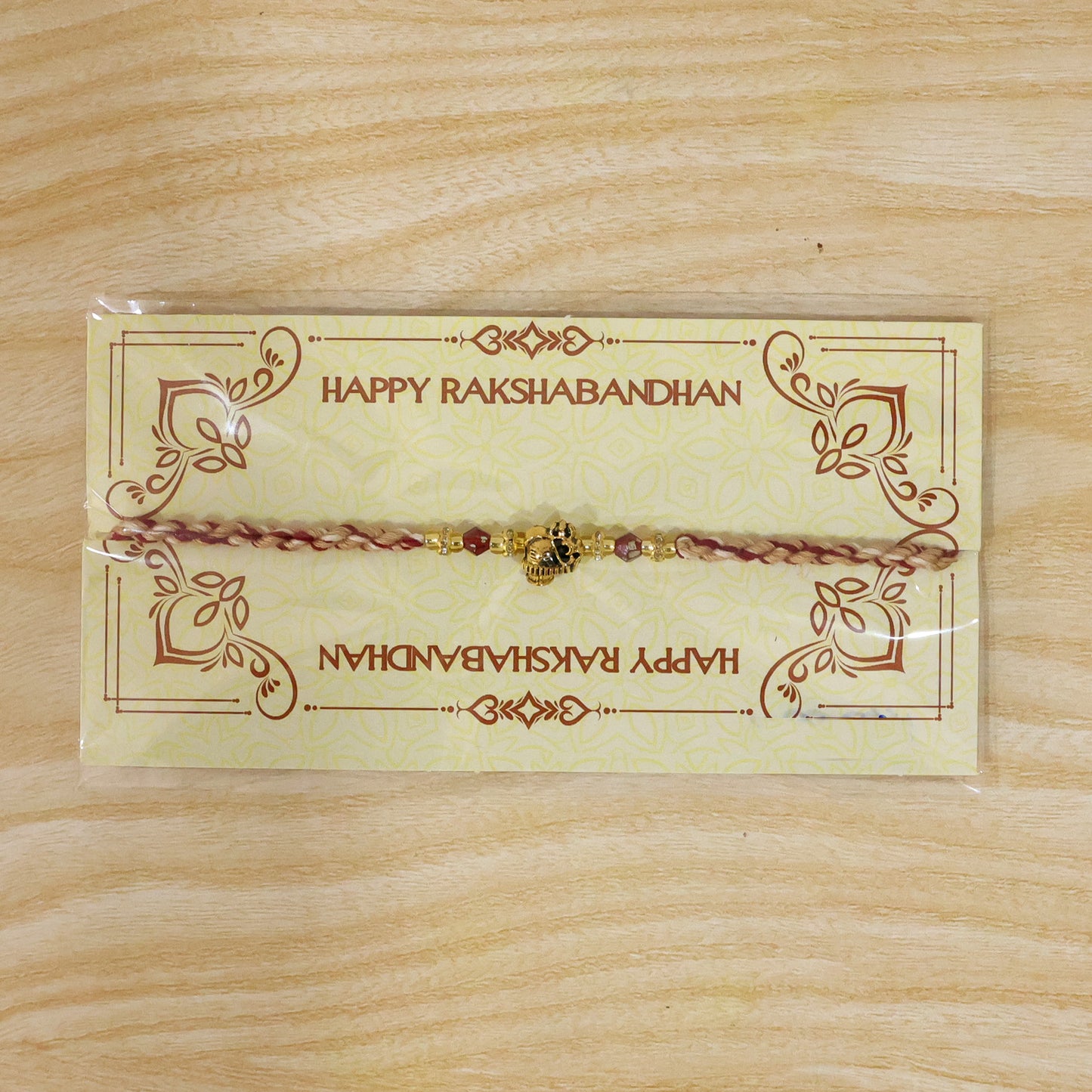 Sacred Deity Rakhi with Red-Beige Thread and Gold Pendant for Raksha Bandhan Gift