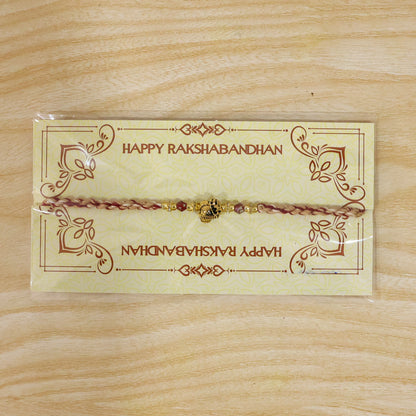 Sacred Deity Rakhi with Red-Beige Thread and Gold Pendant for Raksha Bandhan Gift
