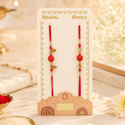 Couple Rakhi with Red Hexagon Charm, Gold Beads and Leaf Accents